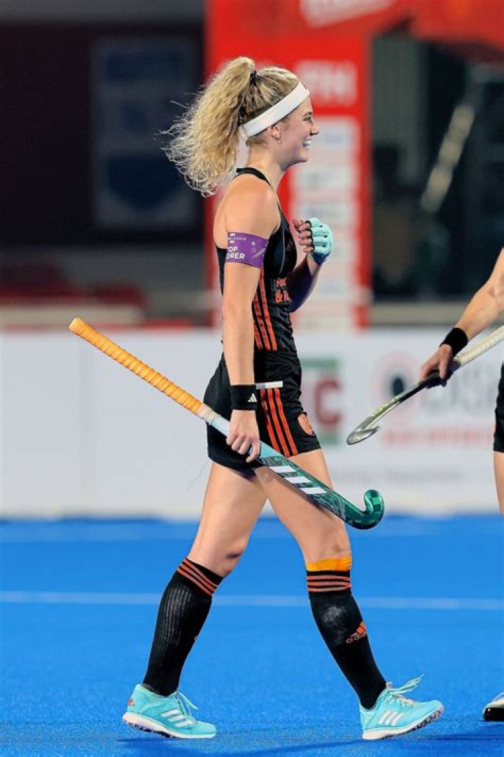 Can a hockey player hold two sticks?